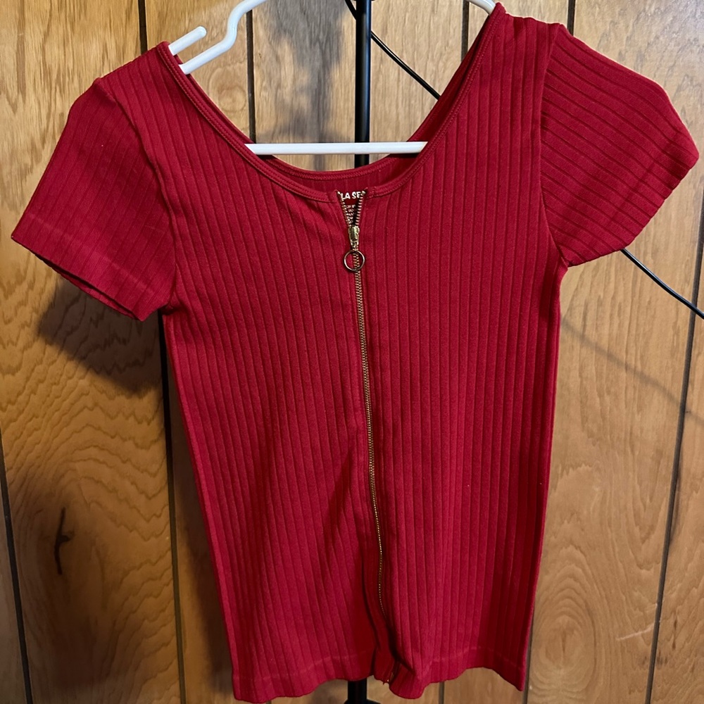 Red short sleeve shirt with gold zipper in middle